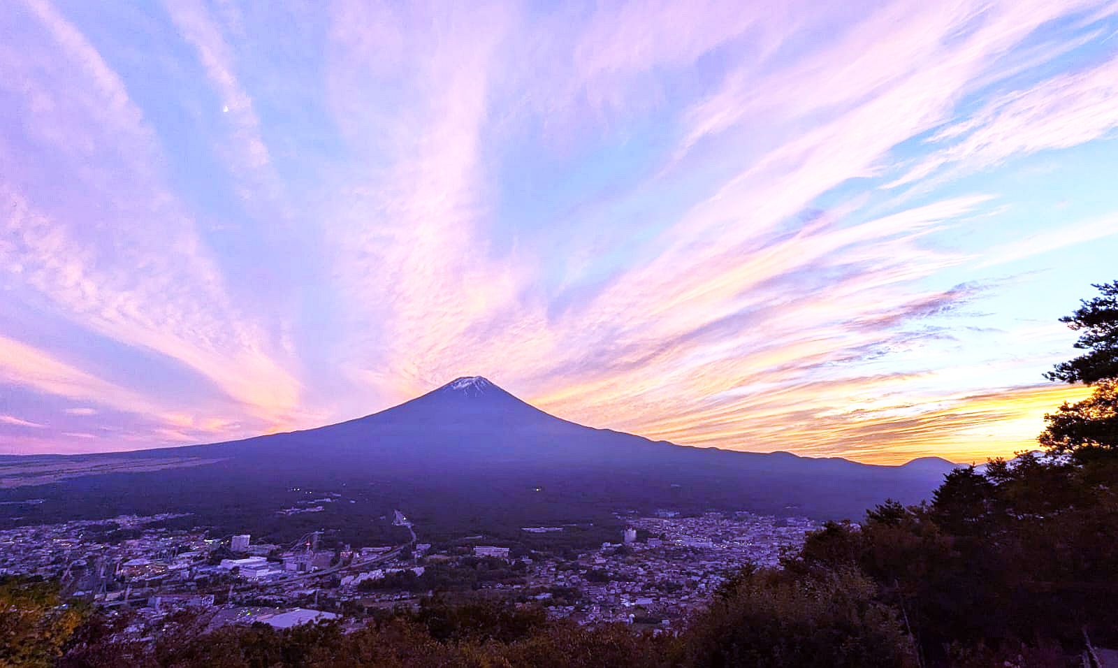 Evening sky over a valley with a mountain in the background in Japan <br>